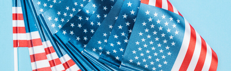 close up view of national american flags on blue background, panoramic shot