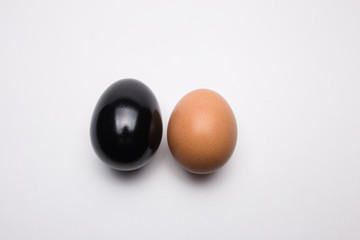 Black and brown egg on a white background close-up
