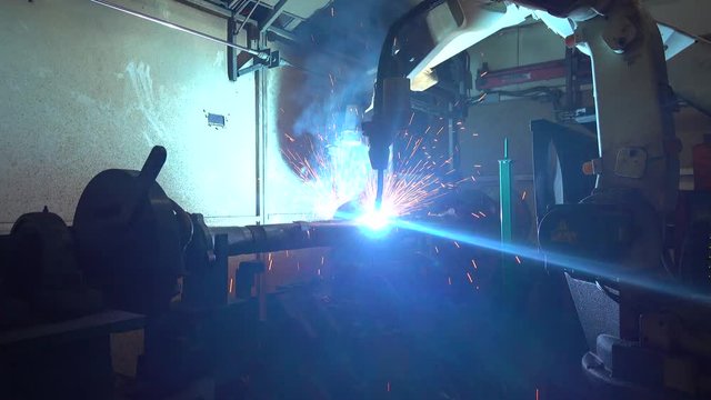 Robotic Arm Welding Machine Technology for manufacturing automotive industrial part in factory. 4k resolution