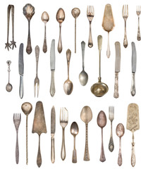 A large set of antiques isolated on a white background. Old spoon, fork, knife, kettle, steamer
