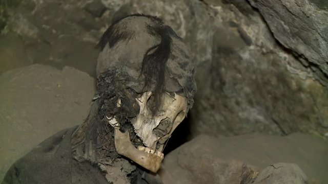 Close-up low-angle still shot of remains of a mummified woman in an ancient burial cemetery, Tunupa, Bolivia
