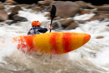 boy in kayak on a fast river © Charly