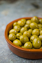 Green olives in clay bowl