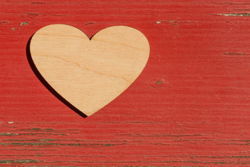 wooden valentine on old red wooden board