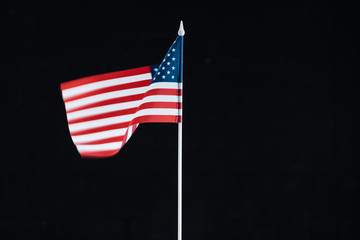 national american flag on stick isolated on black with copy space