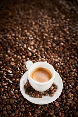 Vertical banner with espresso over coffee beans