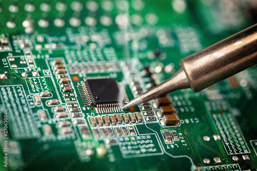 Aufkleber soldering a micro chip processor with iron tool green circuit boad. electroncs service technology an