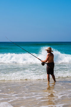 man fishing in the surf