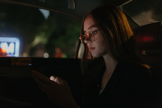 Young woman using a mobile phone in the car