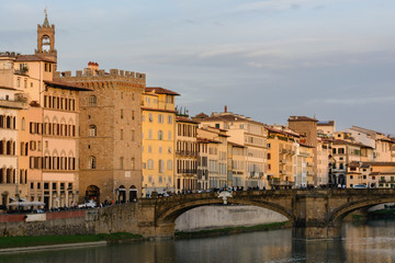 Fototapeta na wymiar The Ponte Vecchio Bridge is a symbol of the city of Florence. It was built in the XIV century over the river Arno. Evening photo.
