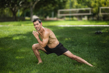 A fit man exercises in the park