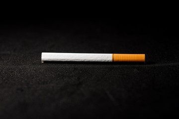 stop smoking concept, a broken cigarette isolated against black, World Tobacco Day