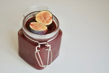 Tasty cherry-fig jam in the glass jar.