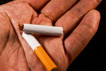 stop smoking concept, a broken cigarette isolated against black, World Tobacco Day