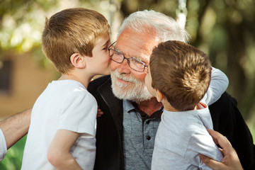 Nephew kissing his grandfather