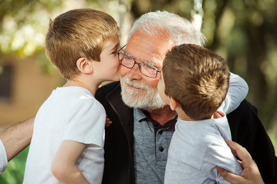 Nephew kissing his grandfather