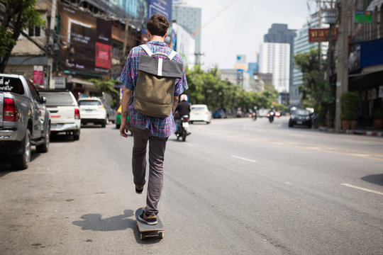 Young man riding a skate downtown
