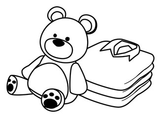 teddy bear toy and folded clothes black and white