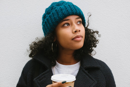 Woman with coffee in city