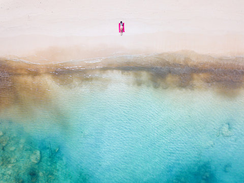 Woman sunbathing alone on an empty beach, Malaysia