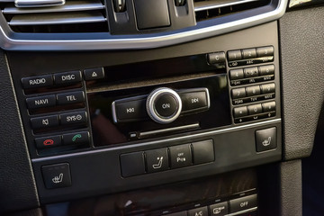 Control buttons for multimedia system, phone connected via bluetooth for talking on the speakerphone in the car on the black panel, heated seats and parking sensors.