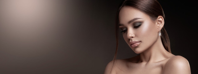 Beauty portrait of model with natural make-up. Fashion shiny highlighter on skin, sexy gloss lips...