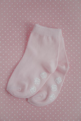 cute pink baby socks on a pink background