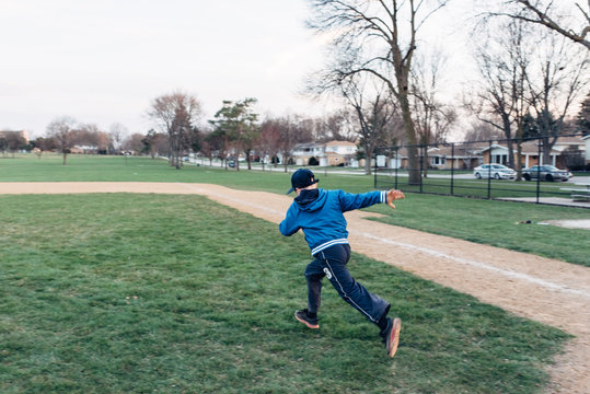 Boy running on a baseball field