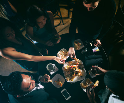 Bar: Friends Sharing Nachos And Having Drinks At Bar
