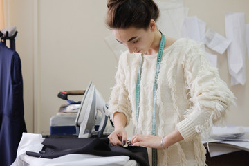 Female tailor working in in the sewing workshop.