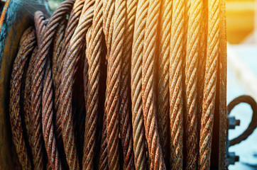 Rusty metal rope wound on a reel. Vintage metal background