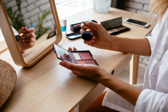 Woman doing makeup at home