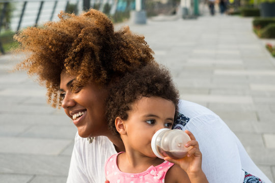 Smiling black mother with daughter