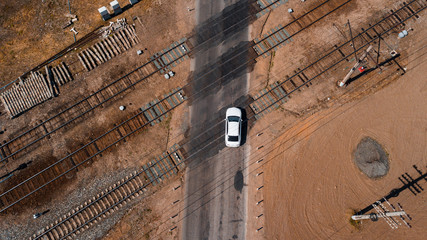 aerial view of a brand new car crossing railway