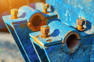 Rusty metal bolts and nuts on metal mounts. Abandoned equipment