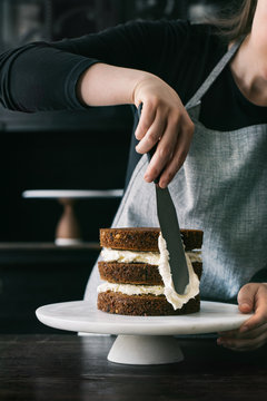 Female Pastry Chef Working on Layered Cake