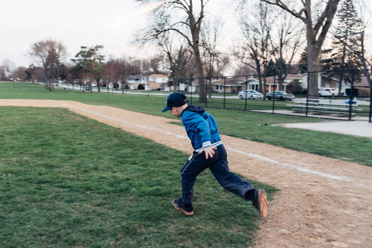 Young boy running on a baseball field