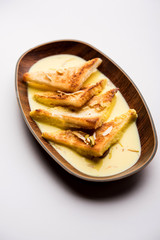 shahi tukra/tukda or Double ka meetha is a bread pudding Indian sweet of fried bread slices soaked in rabid or sweet saffron milk garnished with dry fruits, selective focus