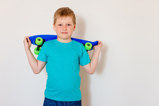 Child holds a skate on a white background