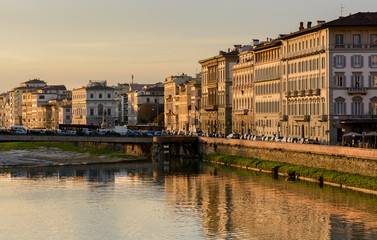 Fototapeta na wymiar The best evening view of the Arno River and Lungarno Pacinotti opens from Ponte Grazzi Bridge. Florence
