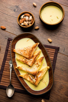 shahi tukra/tukda or Double ka meetha is a bread pudding Indian sweet of fried bread slices soaked in rabid or sweet saffron milk garnished with dry fruits, selective focus