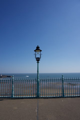 Obraz premium Lampost and railings in Scarborough, UK on a clear blue sky sunny day