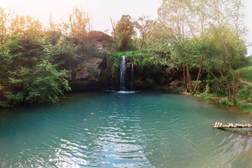 Obraz premium Aerial wide view of paradise Waterfall in Deep forest blue lagoon. Best place. Travel tour concept, nature landscape. Byrbyn Ukraine