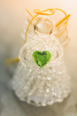 One small glass angel statuette with hearts