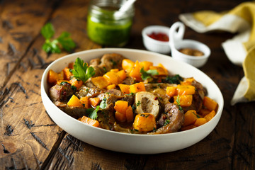 Beef on the bone with pumpkin and pesto