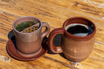 two clay mugs with a drink inside