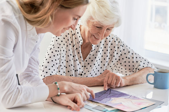 Woman Showing Painting To Grandma