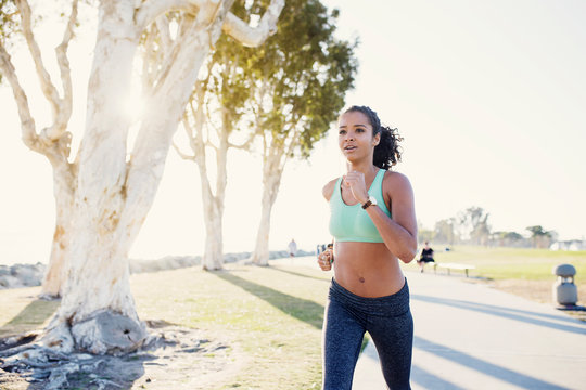 Girl Running on Sunny Path in San Diego
