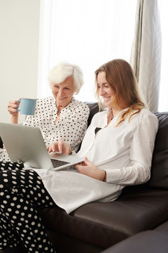 Woman Using Laptop With Grandma