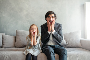 Father and daughter look both shocked something